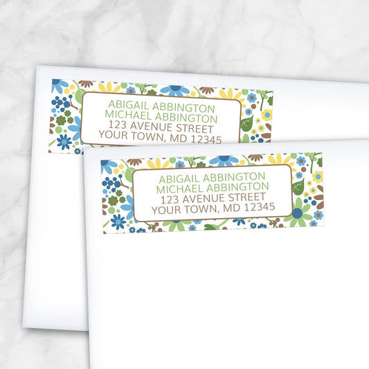 2 Sunny Summer Flowers Address Labels in blue, green, yellow, and brown, shown on white envelopes on a marble surface