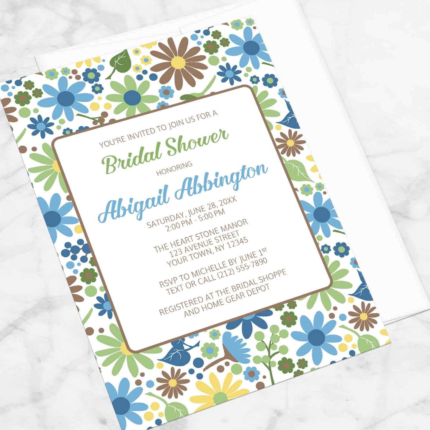 Sunny Summer Flowers Bridal Shower Invitation shown at an angle on a marble surface.