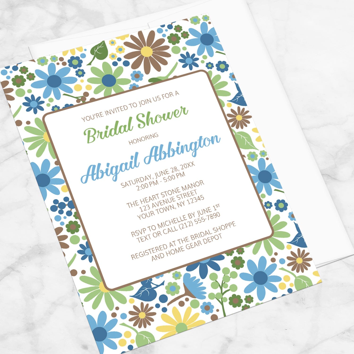 Sunny Summer Flowers Bridal Shower Invitation shown at an angle on a marble surface.