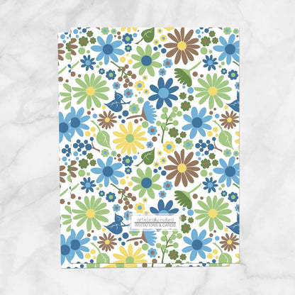 The backside of the bridal Shower invitation (designed flowers in blue, green, yellow, and brown) is printed when the printed invitations upgrade is selected. Invitation is shown on a marble surface.