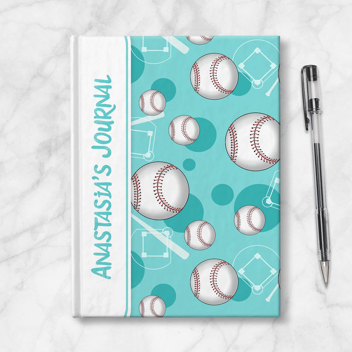 Personalized Teal Baseball Journal at Artistically Invited. Image shows the book on a countertop next to a pen.