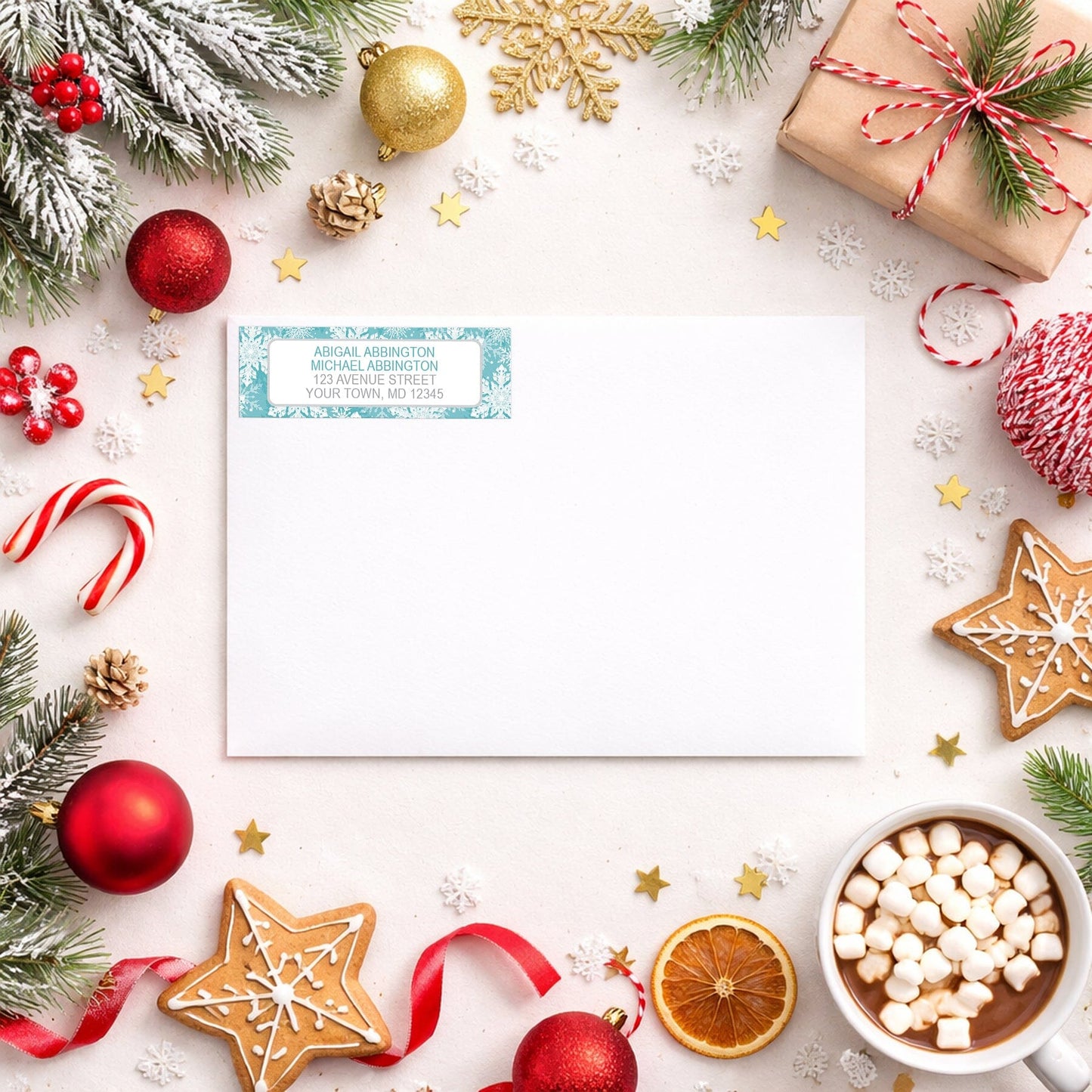 Teal Snowflake Winter Return Address Label shown on a white envelope with winter Christmas holiday supplies