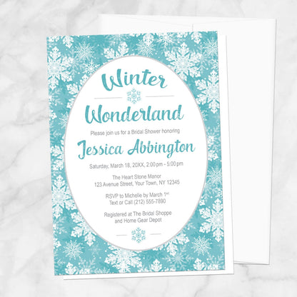 Teal Snowflake Winter Wonderland Bridal Shower Invitation shown on a marble surface with a white envelope.