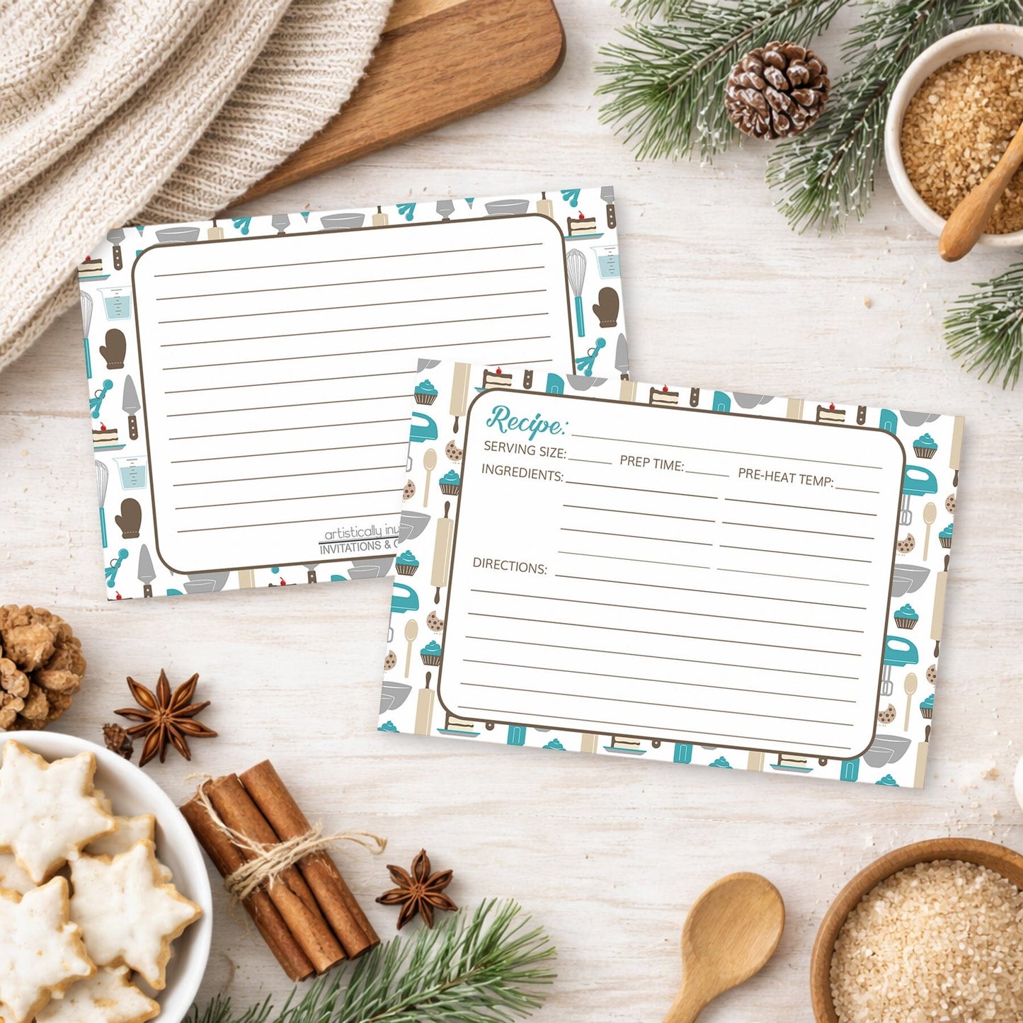 Two Turquoise Baking Pattern Recipe Cards on a wooden surface with holiday decorations and cookies.