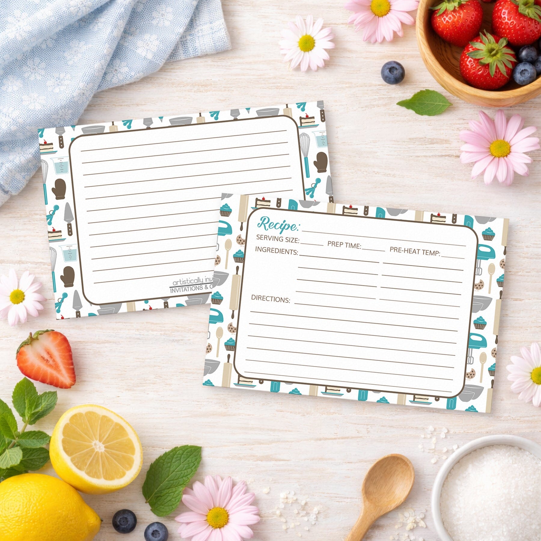 Two Turquoise Baking Pattern Recipe Cards on a wooden surface with spring and summer fruits and flowers