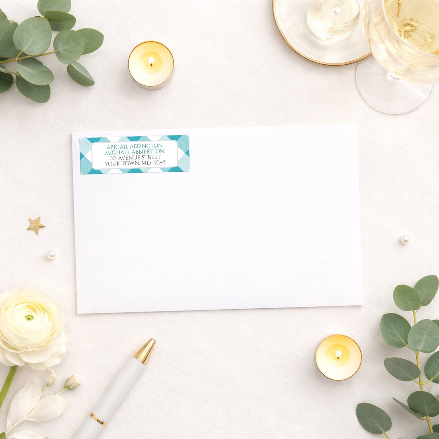 Turquoise Gingham Address Label shown on a white envelope with wedding and shower supplies