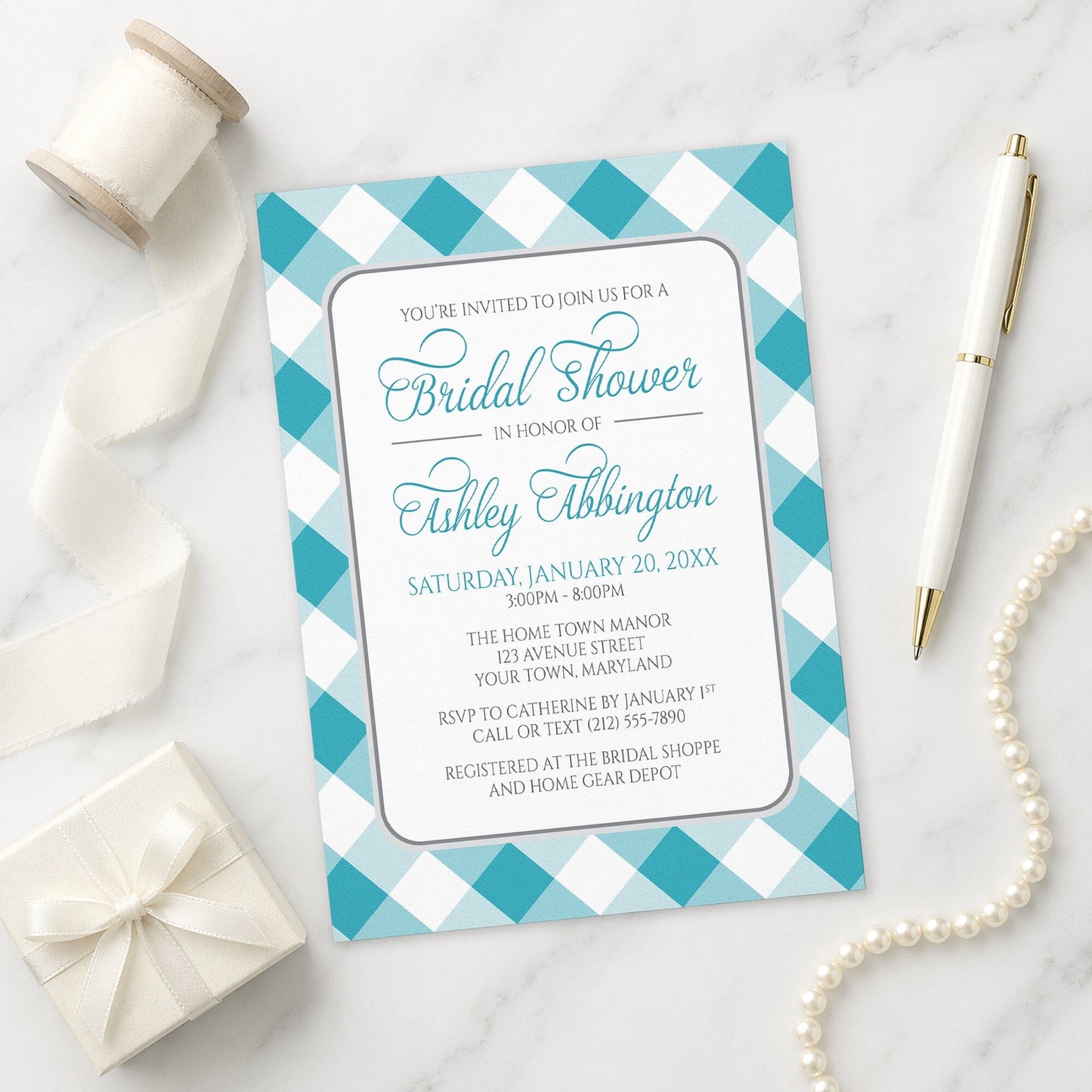 Turquoise Gingham Bridal Shower Invitation with a checkered border on a marble surface with ribbon and pen.