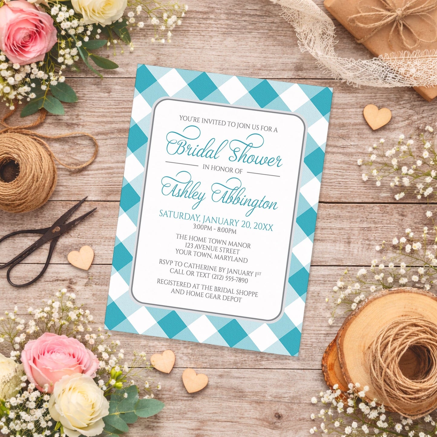 Turquoise Gingham Bridal Shower Invitation with a checkered border on a wooden surface with flowers and twine.
