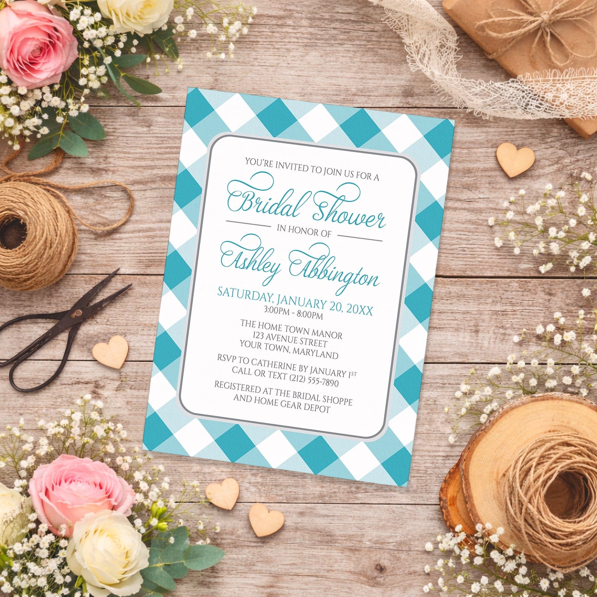 Turquoise Gingham Bridal Shower Invitation with a checkered border on a wooden surface with flowers and twine.
