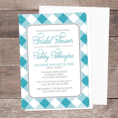 Bridal shower invitation with turquoise and white check border, displayed with a white envelope on a wooden surface