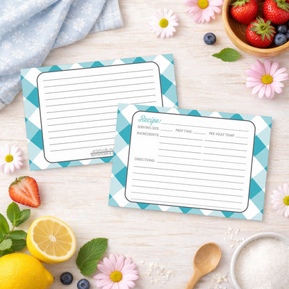 Two Turquoise Gingham Recipe Cards on a wooden surface with spring and summer fruits and flowers.