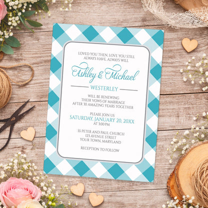 Turquoise Gingham Vow Renewal Invitation shown on a wooden surface with spring and summer flowers, small wood hearts, lace, and twine.