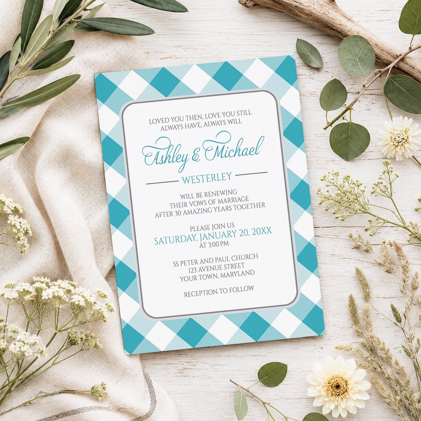 Turquoise Gingham Vow Renewal Invitation shown on a light wooden surface with spring and summer plants.