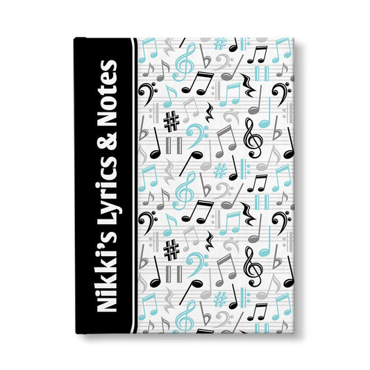 Personalized Turquoise Music Notes Pattern Journal at Artistically Invited. A custom book designed with a black color wrapping around the spine area over an energetic pattern of turquoise, black, and gray music notes and symbols on the rest of the background. Your personalized name and text of your choice is custom printed sideways in white over the black color on the front near the spine.