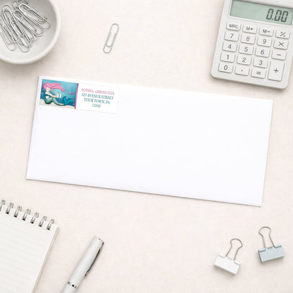 Under the Sea Mermaid Return Address Label shown on a white envelope with everyday office supplies