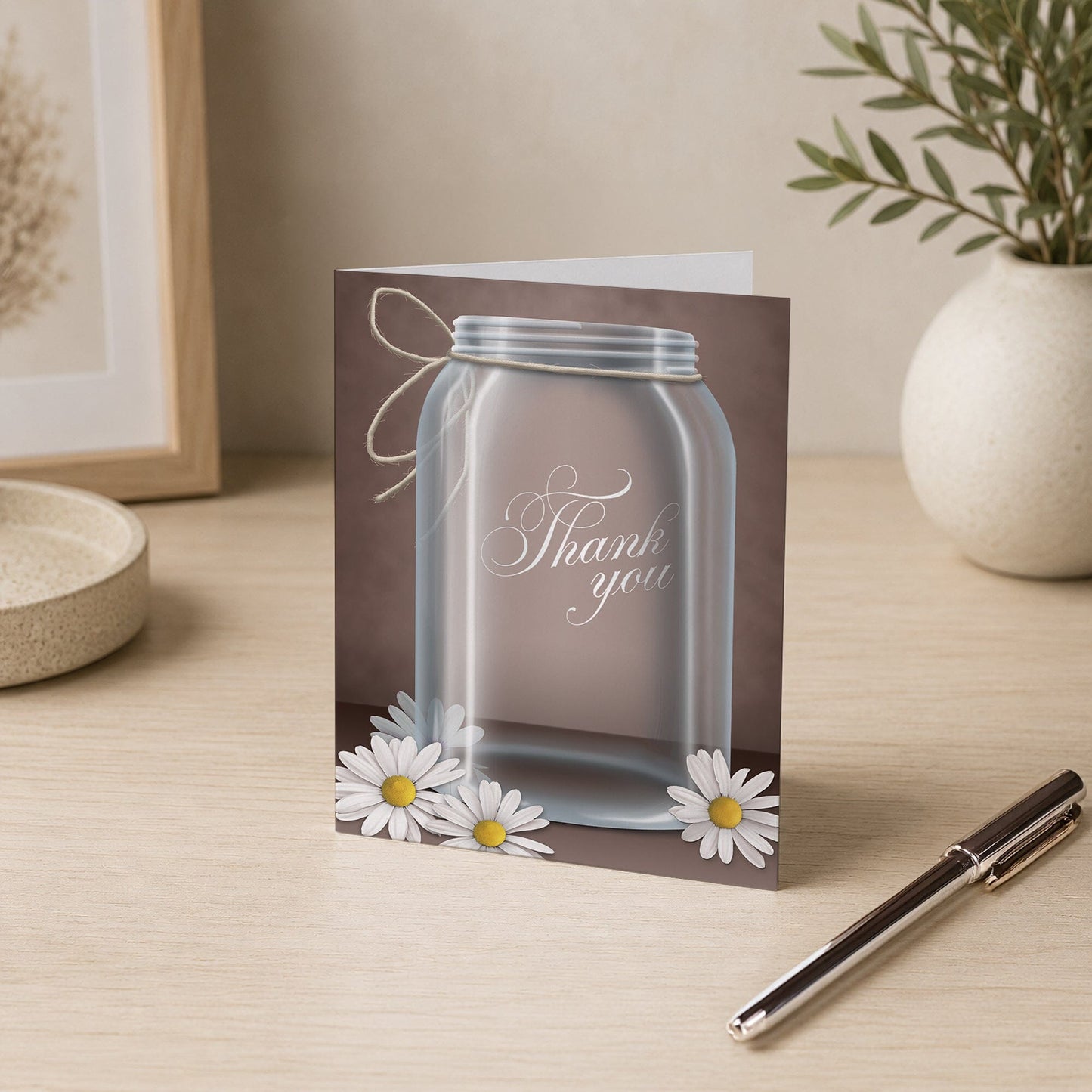 Vintage Rustic Mason Jar Daisy Thank You Card shown on a desk with a vase and a pen.