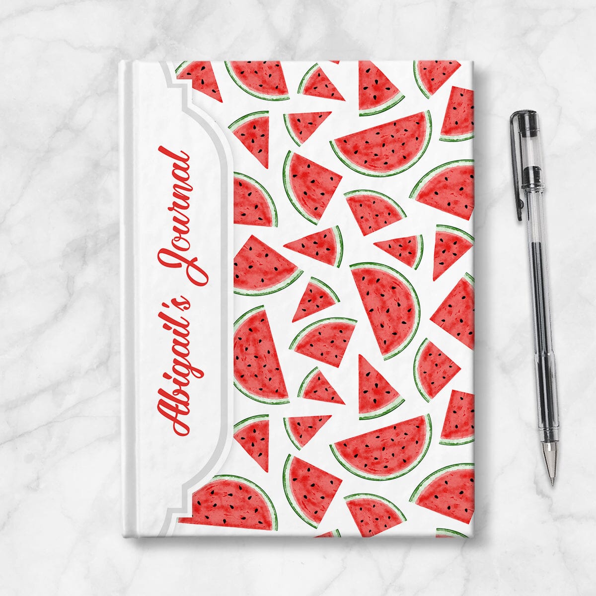 Personalized Watermelon Slices Journal at Artistically Invited. Image shows the book on a countertop next to a pen.
