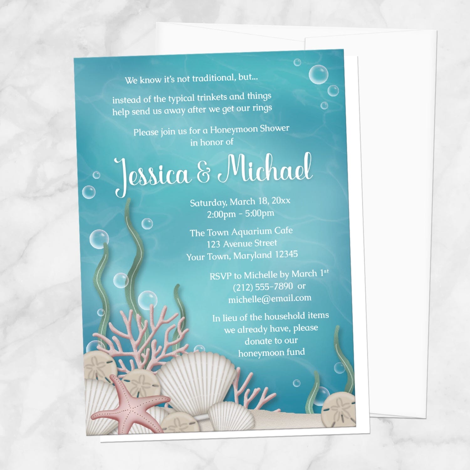 Whimsical Under the Sea Honeymoon Shower Invitation shown on a marble surface with a white envelope.