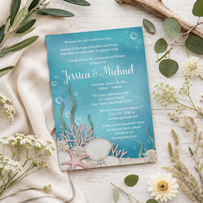 Whimsical Under the Sea Honeymoon Shower Invitation shown on a light wood surface with summer plants.