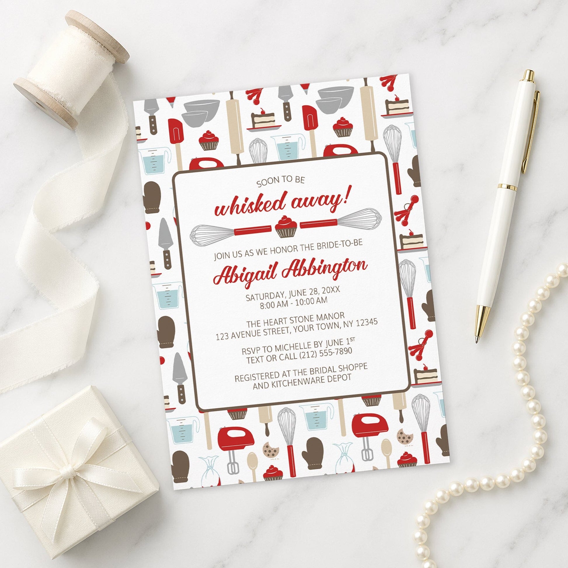 Whisked Away Red Baking Bridal Shower Invitation with kitchen-themed design on a marble surface with decorative items.