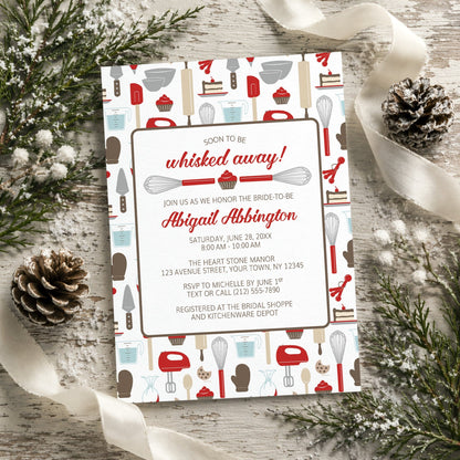 Whisked Away Red Baking Bridal Shower Invitation with kitchen-themed design on a decorative background with pine cones and ribbons.