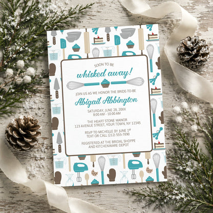 Whisked Away Turquoise Baking Bridal Shower Invitation with a kitchen tools and sweets theme, shown on a rustic wooden surface with winter greenery, pine cones, and ribbons.
