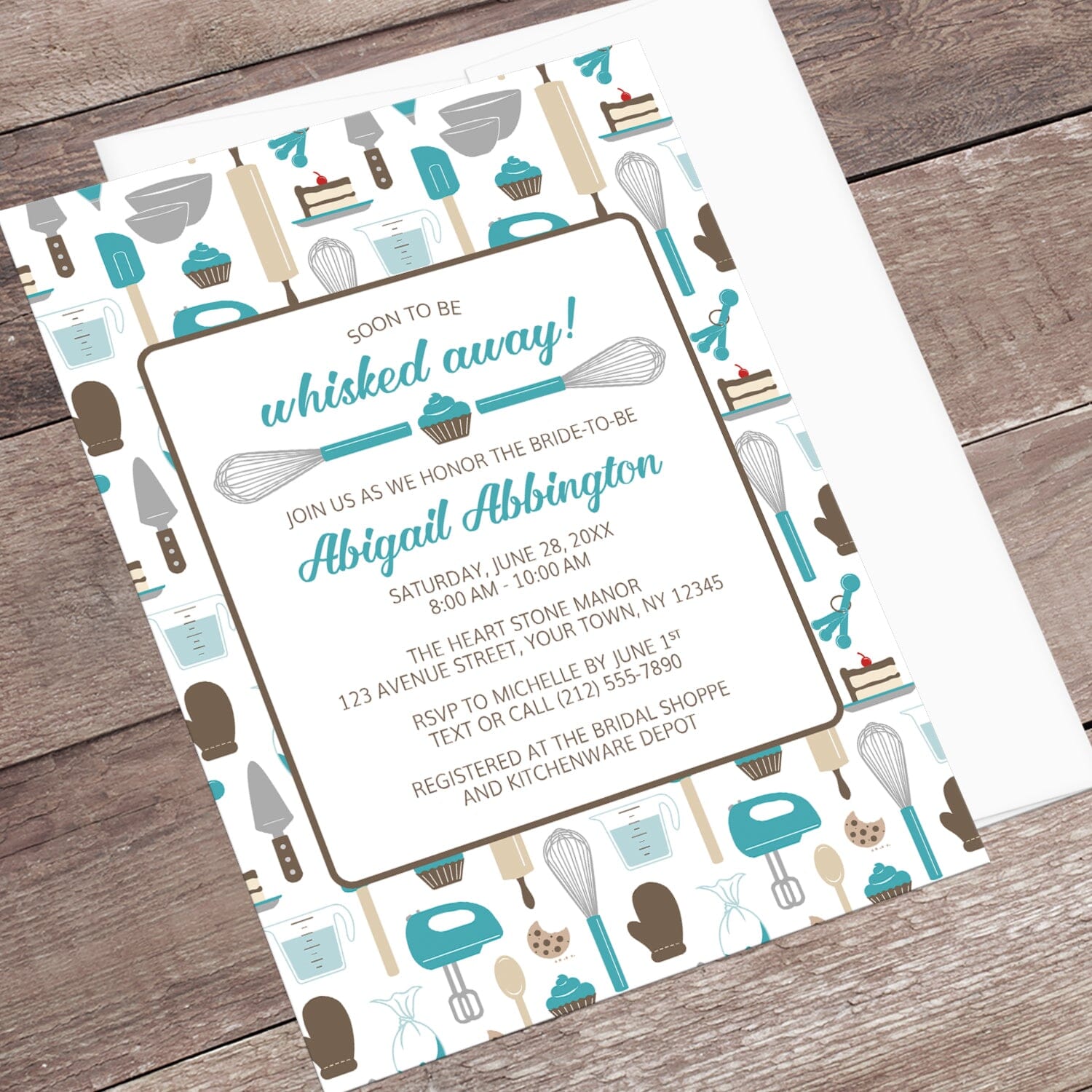 Whisked Away Turquoise Baking Bridal Shower Invitation with a kitchen tools and sweets theme, shown at an angle on a wooden surface with a white envelope.