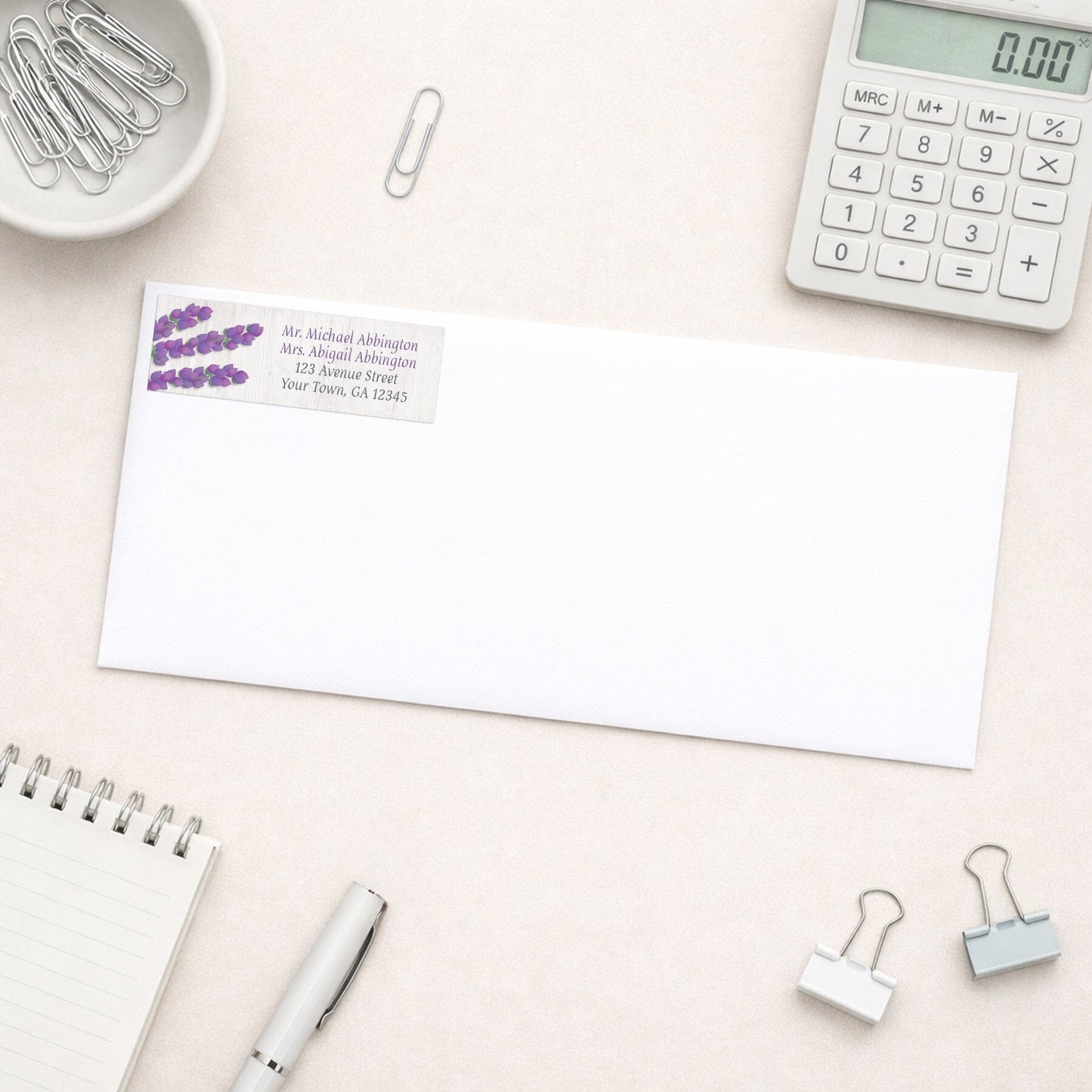 Whitewashed Wood Lavender Address Label shown on a white envelope with everyday office supplies