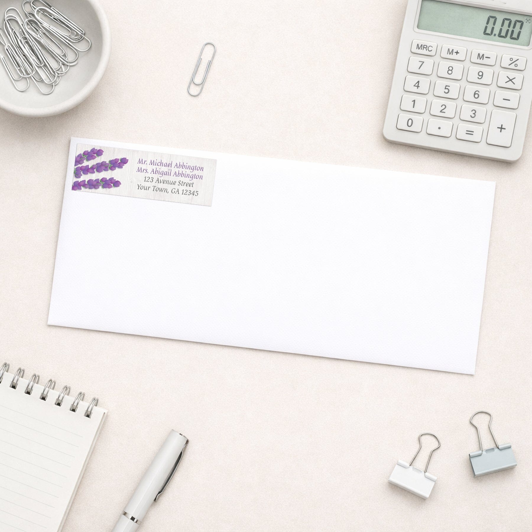 Whitewashed Wood Lavender Address Label shown on a white envelope with everyday office supplies