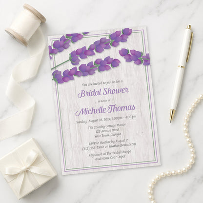 Whitewashed Wood Lavender Bridal Shower Invitation shown on a marble surface with decorative items.