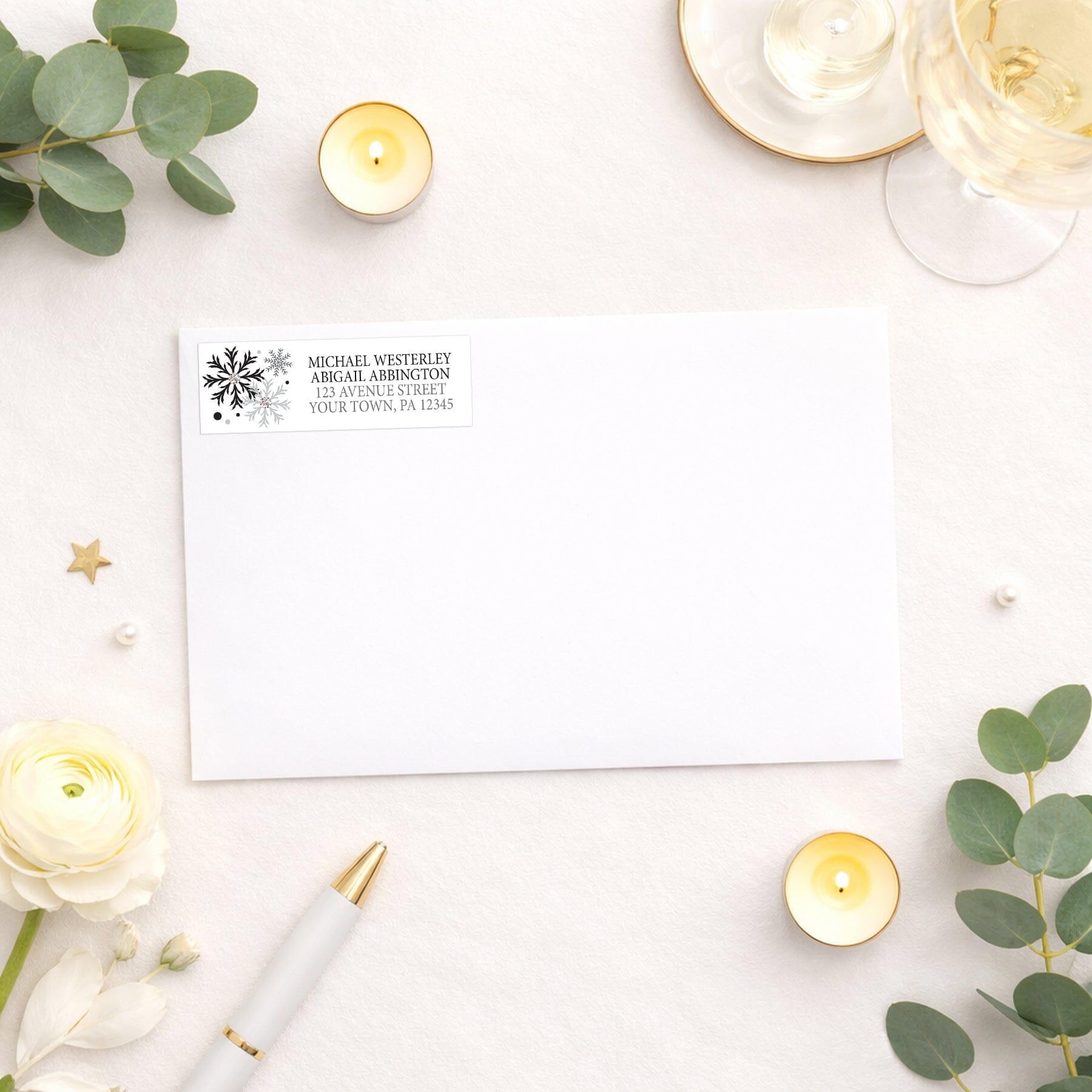 Winter Black Silver Snowflake Address Label shown on a white envelope with wedding and shower supplies