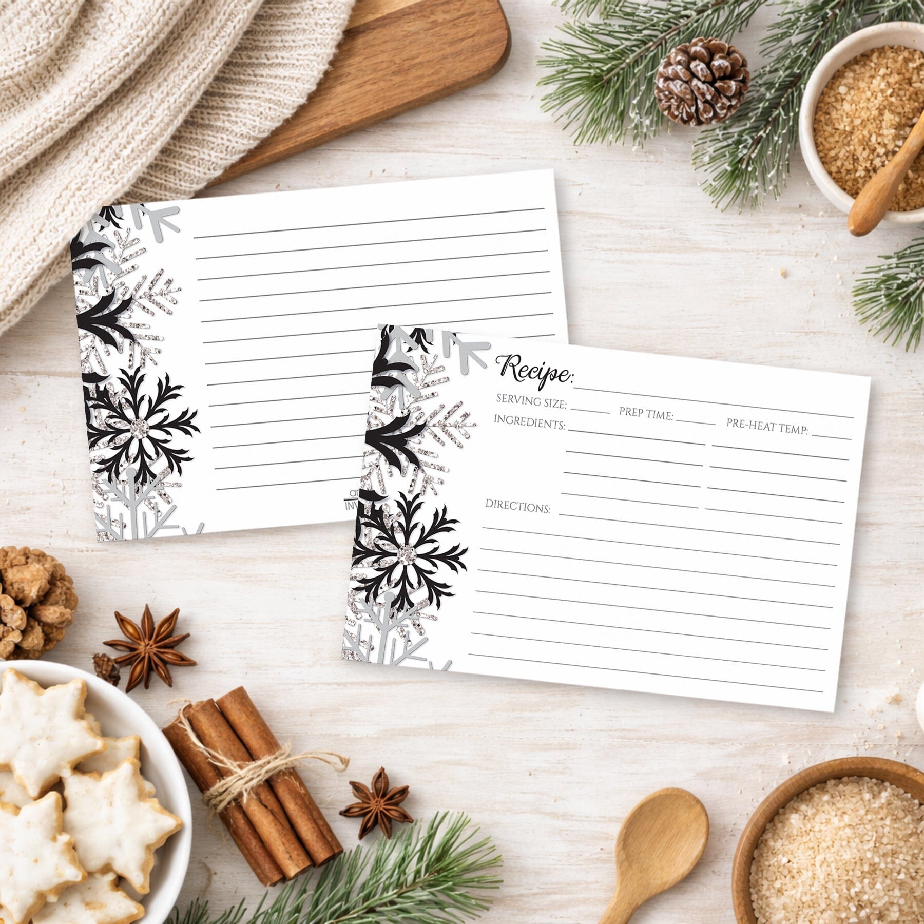 Two Winter Black Silver Snowflake Recipe Cards on a festive table with holiday cookies and spices.