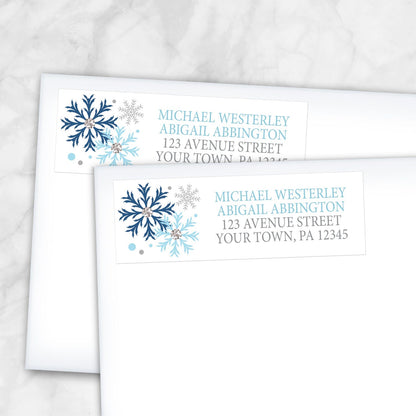 2 Winter Blue Silver Snowflake Address Labels shown on white envelopes on a marble surface