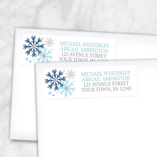 2 Winter Blue Silver Snowflake Address Labels shown on white envelopes on a marble surface