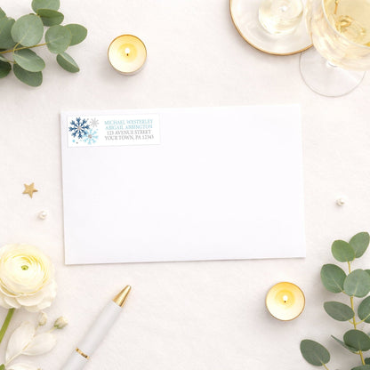 Winter Blue Silver Snowflake Address Label shown on a white envelope with wedding and shower supplies