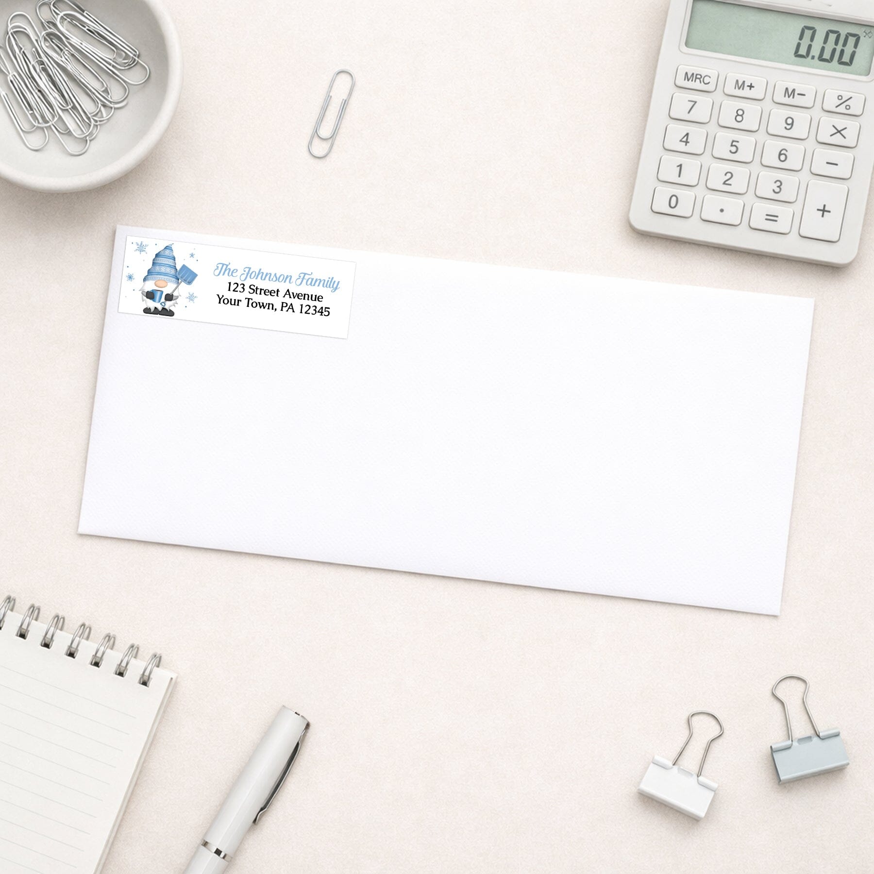 Winter Gnome Address Label shown on a white envelope with office supplies