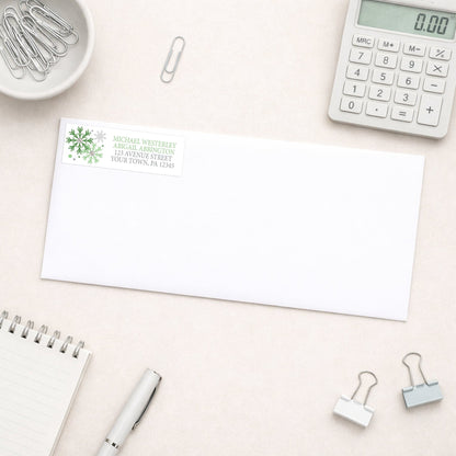 Winter Green Silver Snowflake Address Label shown on a white envelope with office supplies