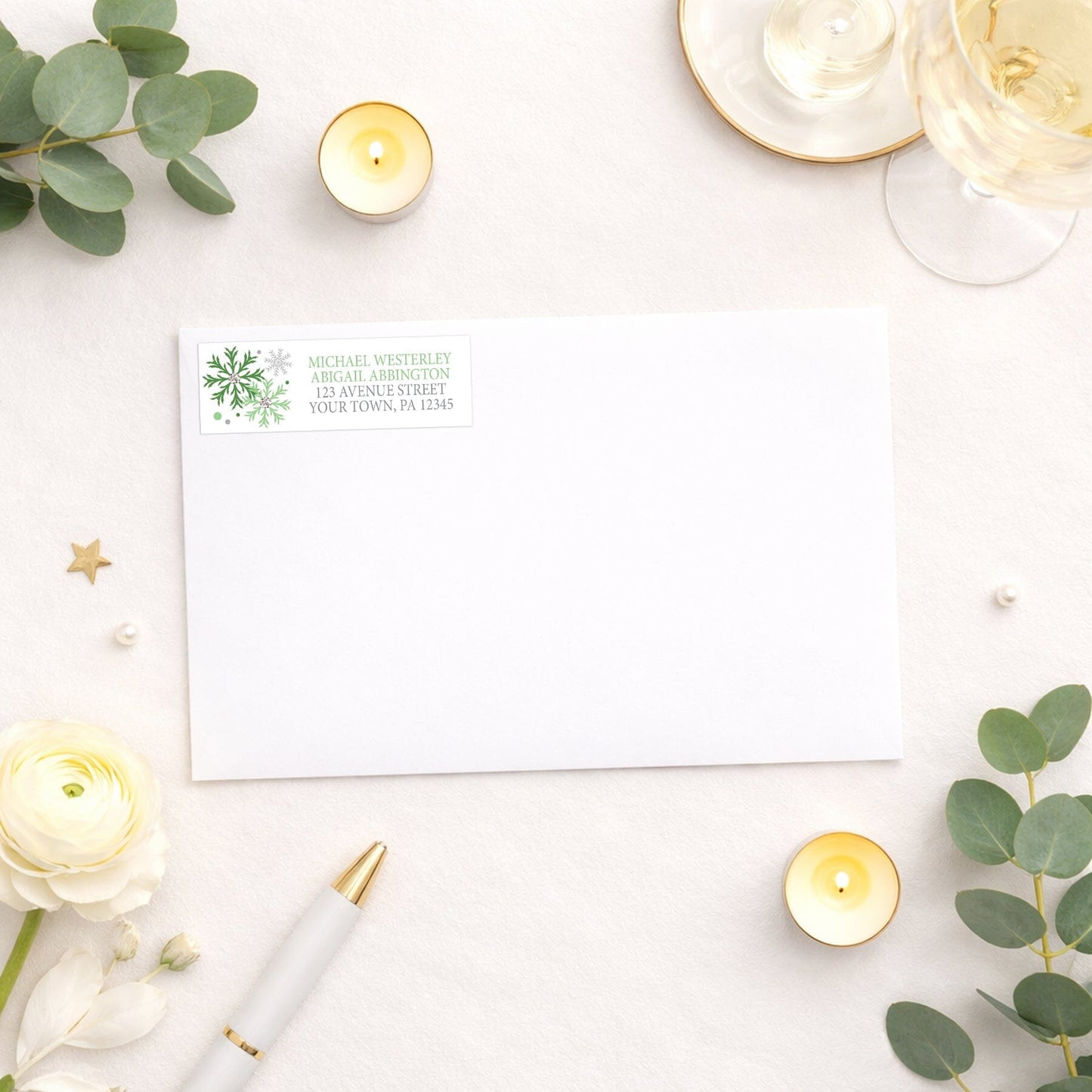 Winter Green Silver Snowflake Address Label shown on a white envelope with wedding and shower supplies