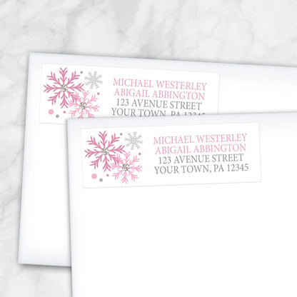 2 Winter Pink Silver Snowflake Address Labels shown on white envelopes on a marble surface