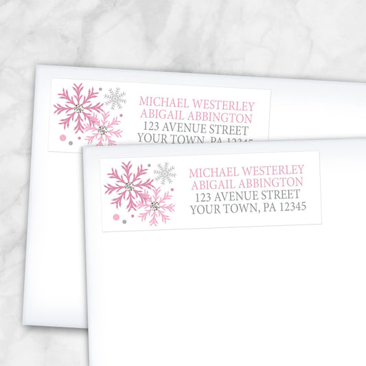 2 Winter Pink Silver Snowflake Address Labels shown on white envelopes on a marble surface