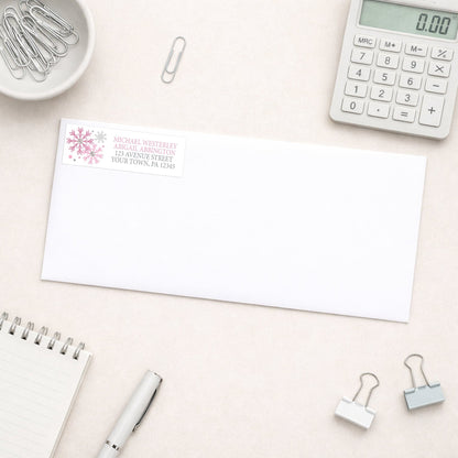 Winter Pink Silver Snowflake Address Label shown on a white envelope with everyday office supplies