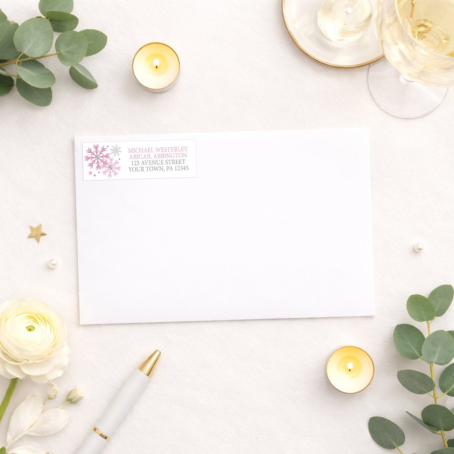 Winter Pink Silver Snowflake Address Label shown on a white envelope with wedding and shower supplies