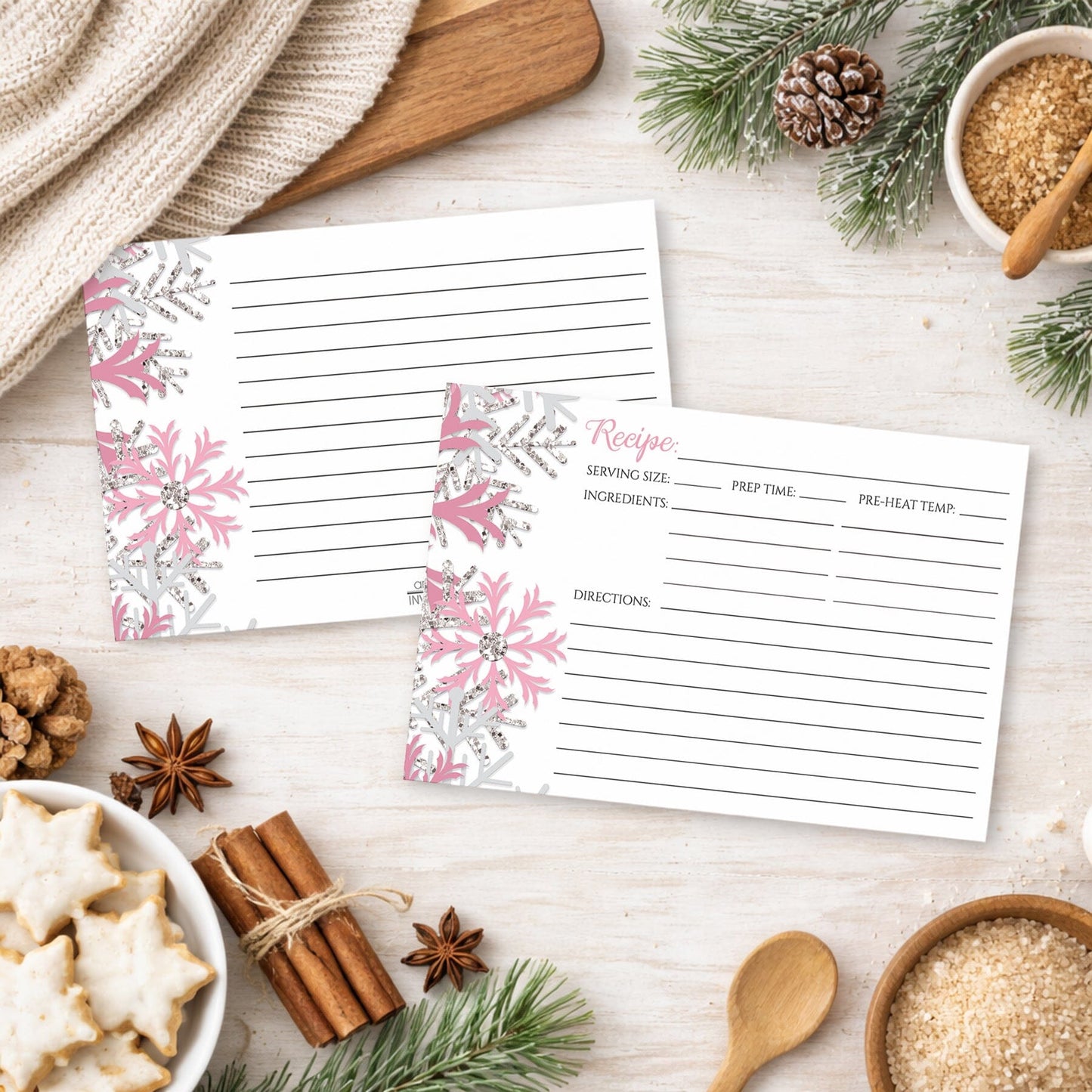 Two Winter Pink Silver Snowflake Recipe Cards on a festive table with holiday cookies, spices, and winter decor.