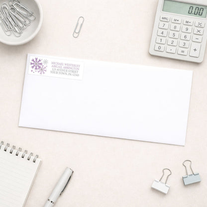 Winter Purple Silver Snowflake Address Label shown on a white envelope with everyday office supplies