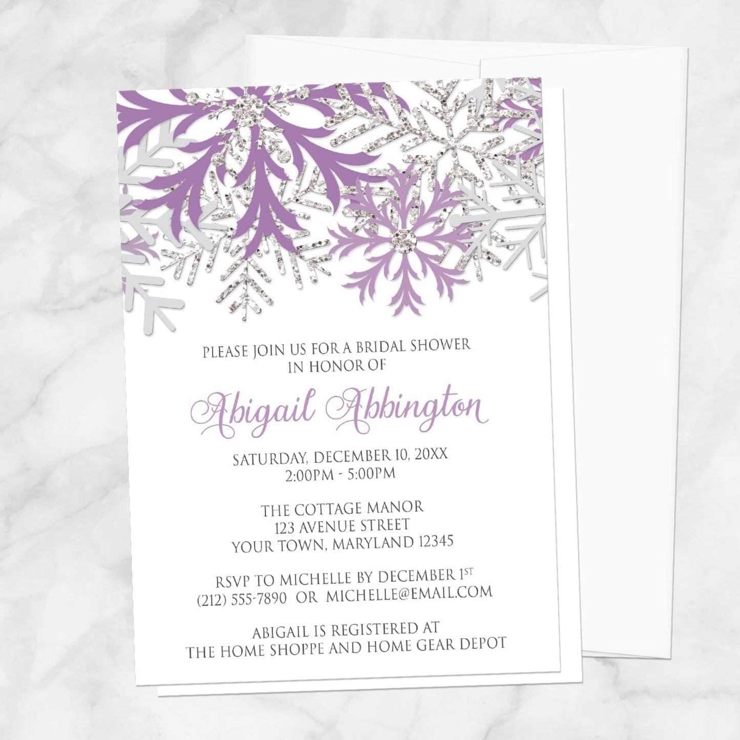 Winter Purple Silver Snowflake Bridal Shower Invitation shown on a marble surface with a white envelope.