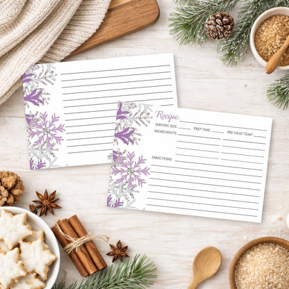Two Winter Purple Silver Snowflake Recipe Cards on a festive table with holiday cookies and spices.
