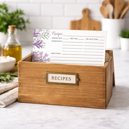Wooden recipe box with a Winter Purple Silver Snowflake Recipe Card inside, set against a kitchen backdrop.