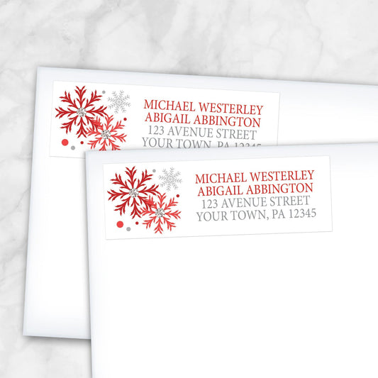 2 Winter Red Silver Snowflake Address Labels shown on white envelopes on a marble surface