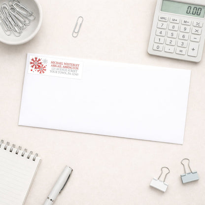 Winter Red Silver Snowflake Address Label shown on a white envelope with everyday office supplies