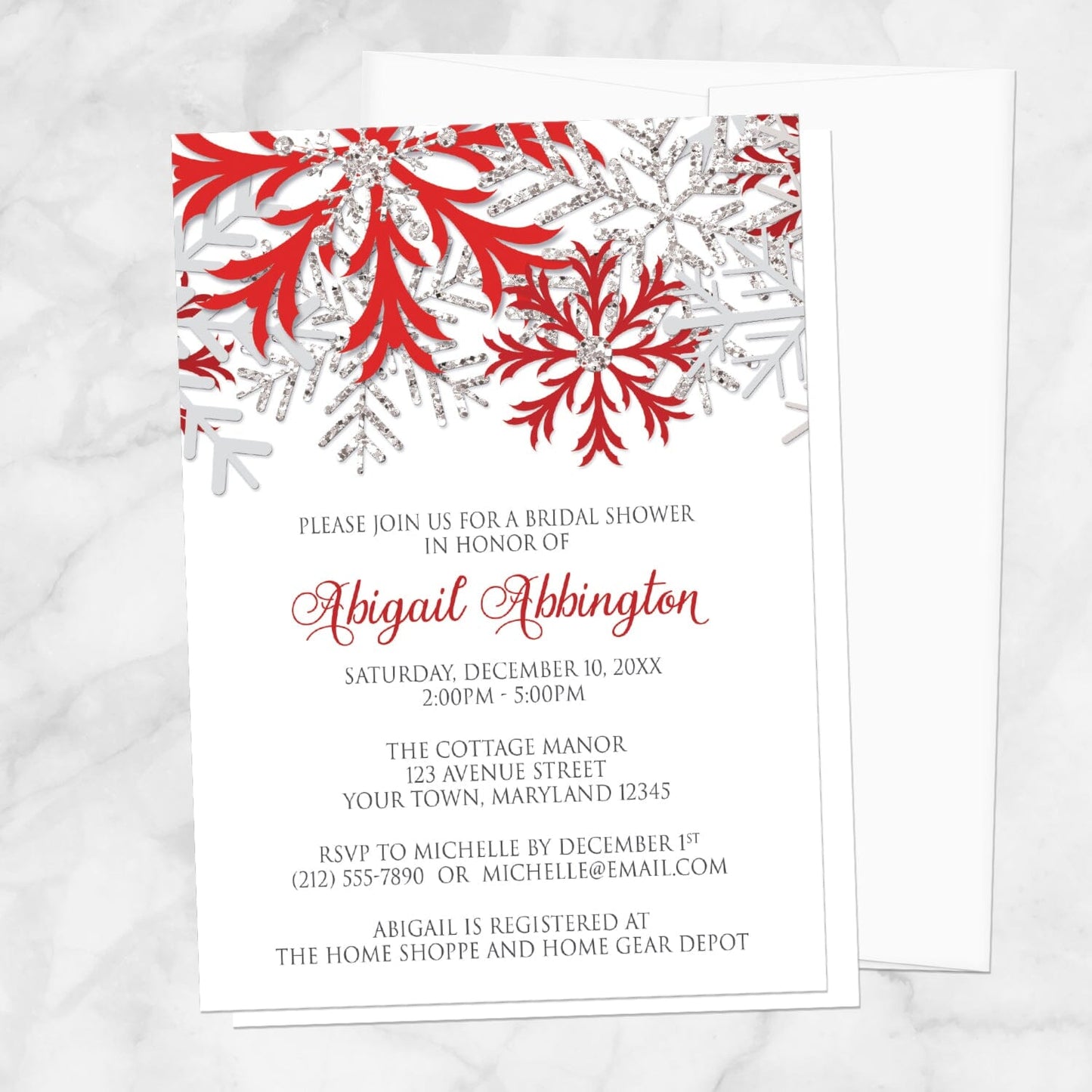 Winter Red Silver Snowflake Bridal Shower Invitation shown on a marble surface with a white envelope.